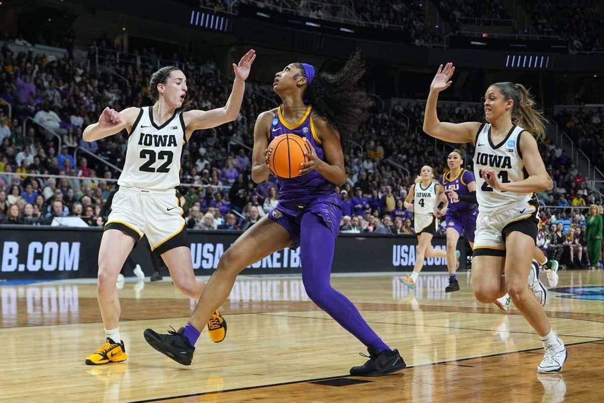 Apr 1, 2024; Albany, NY, USA; LSU Lady Tigers forward Angel Reese (10) controls the ball against Iowa Hawkeyes guard Caitlin Clark (22) and guard Gabbie Marshall (24) in the first half in the finals of the Albany Regional in the 2024 NCAA Tournament at MVP Arena.