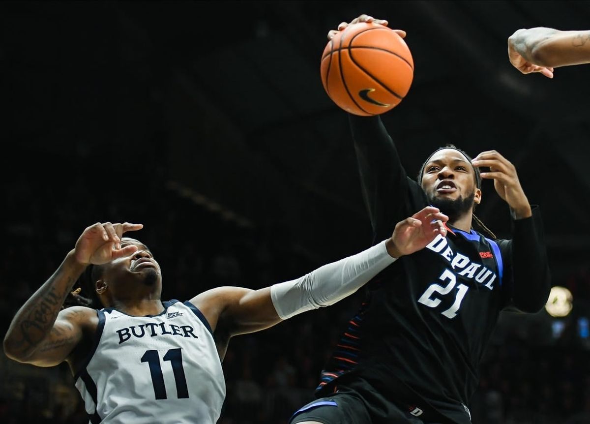 Jan 20, 2024; Indianapolis, Indiana, USA;  Butler Bulldogs guard Jahmyl Telfort (11) and DePaul Blue Demons forward Da'Sean Nelson (21) battle for a rebound during the second half at Hinkle Fieldhouse.