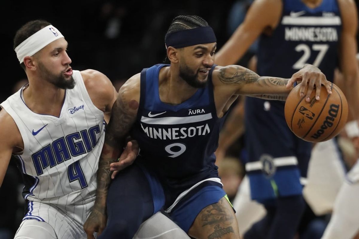 Feb 2, 2024; Minneapolis, Minnesota, USA; Minnesota Timberwolves guard Nickeil Alexander-Walker (9) works around Orlando Magic guard Jalen Suggs (4) in the fourth quarter at Target Center.