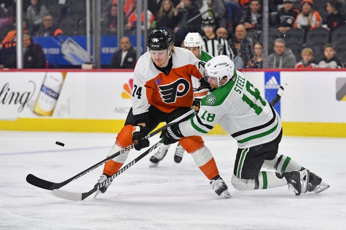 Jan 18, 2024; Philadelphia, Pennsylvania, USA; Philadelphia Flyers right wing Owen Tippett (74) and Dallas Stars center Sam Steel (18) battle for the puck during the first period at Wells Fargo Center.
