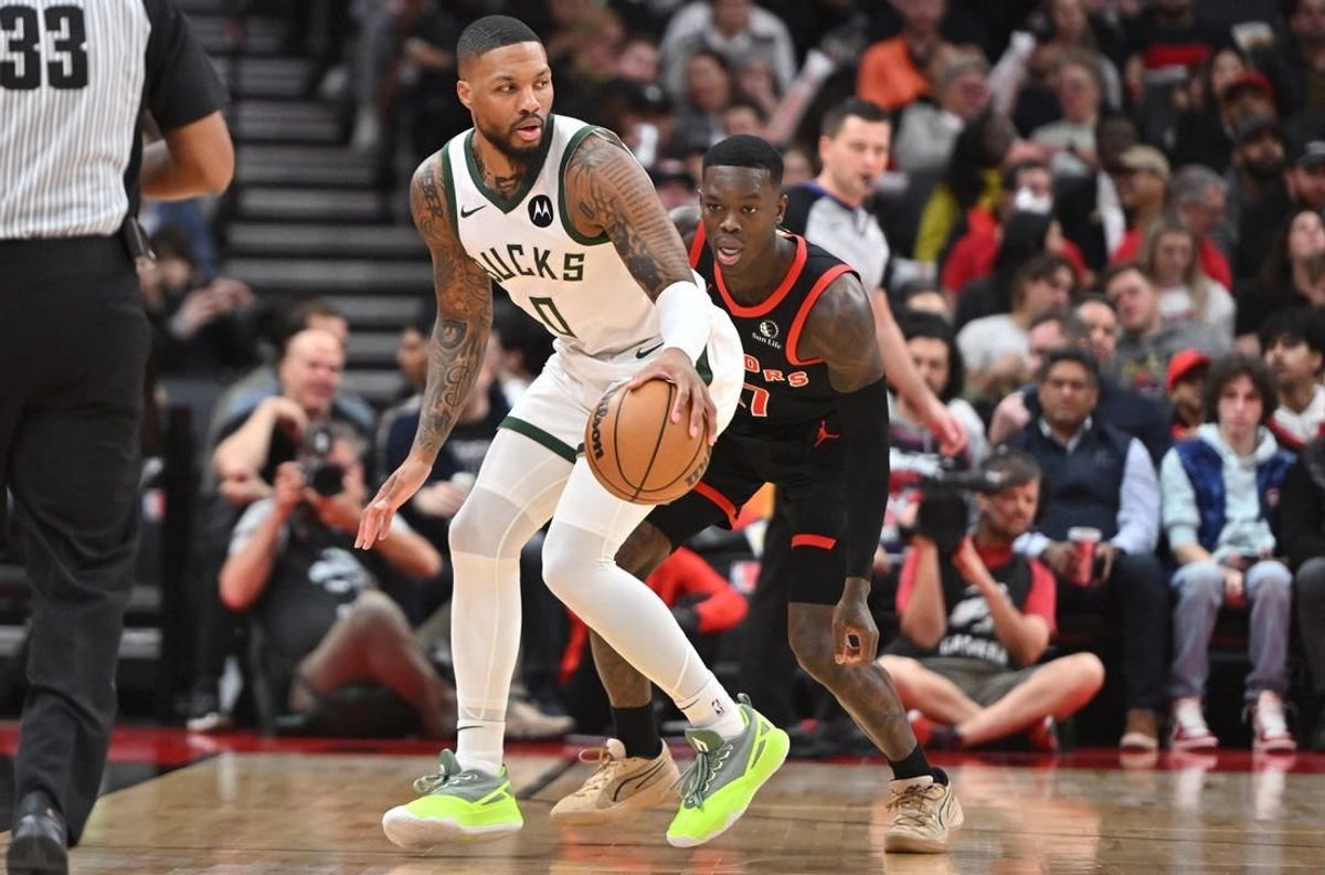 Nov 15, 2023; Toronto, Ontario, CAN;  Milwaukee Bucks guard Damian Lillard (0) controls the ball as Toronto Raptors guard Dennis Schroder (17) defends in the first half at Scotiabank Arena.
