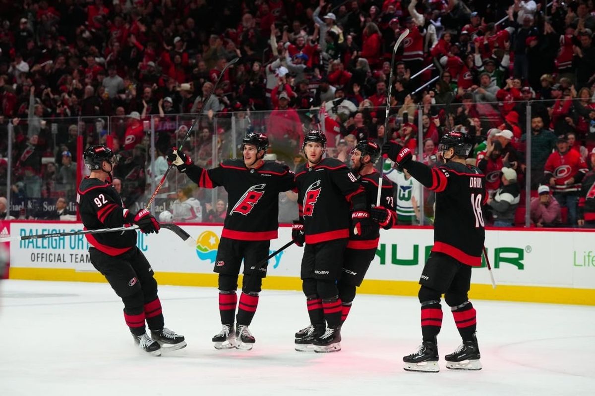 Apr 5, 2024; Raleigh, North Carolina, USA; Carolina Hurricanes center Martin Necas (88) celebrates his goal with center Evgeny Kuznetsov (92) defenseman Brady Skjei (76) right wing Stefan Noesen (23) and center Jack Drury (18) against the Washington Capitals during the third period at PNC Arena.