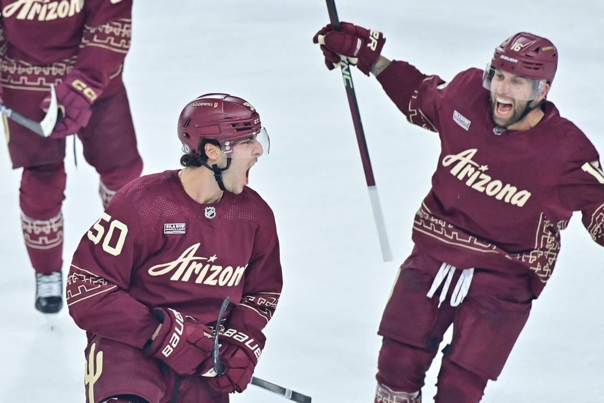 Dec 27, 2023; Tempe, Arizona, USA;  Arizona Coyotes defenseman Sean Durzi (50) celebrates with left wing Jason Zucker (16) after scoring a goal in the third period against the Colorado Avalanche at Mullett Arena.