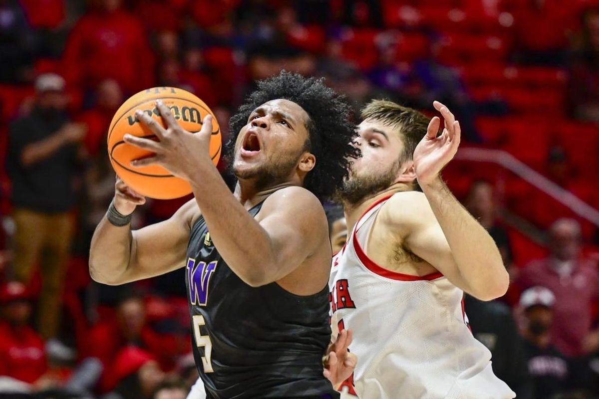 Dec 31, 2023; Salt Lake City, Utah, USA; Washington Huskies guard Sahvir Wheeler (5) takes a shot over Utah Utes guard Rollie Worster (25) during the second half at the the Jon M. Huntsman Center.