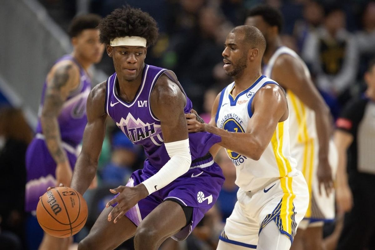 Apr 14, 2024; San Francisco, California, USA; Utah Jazz forward Taylor Hendricks (0) looks to drive around Golden State Warriors guard Chris Paul (3) during the first quarter at Chase Center.