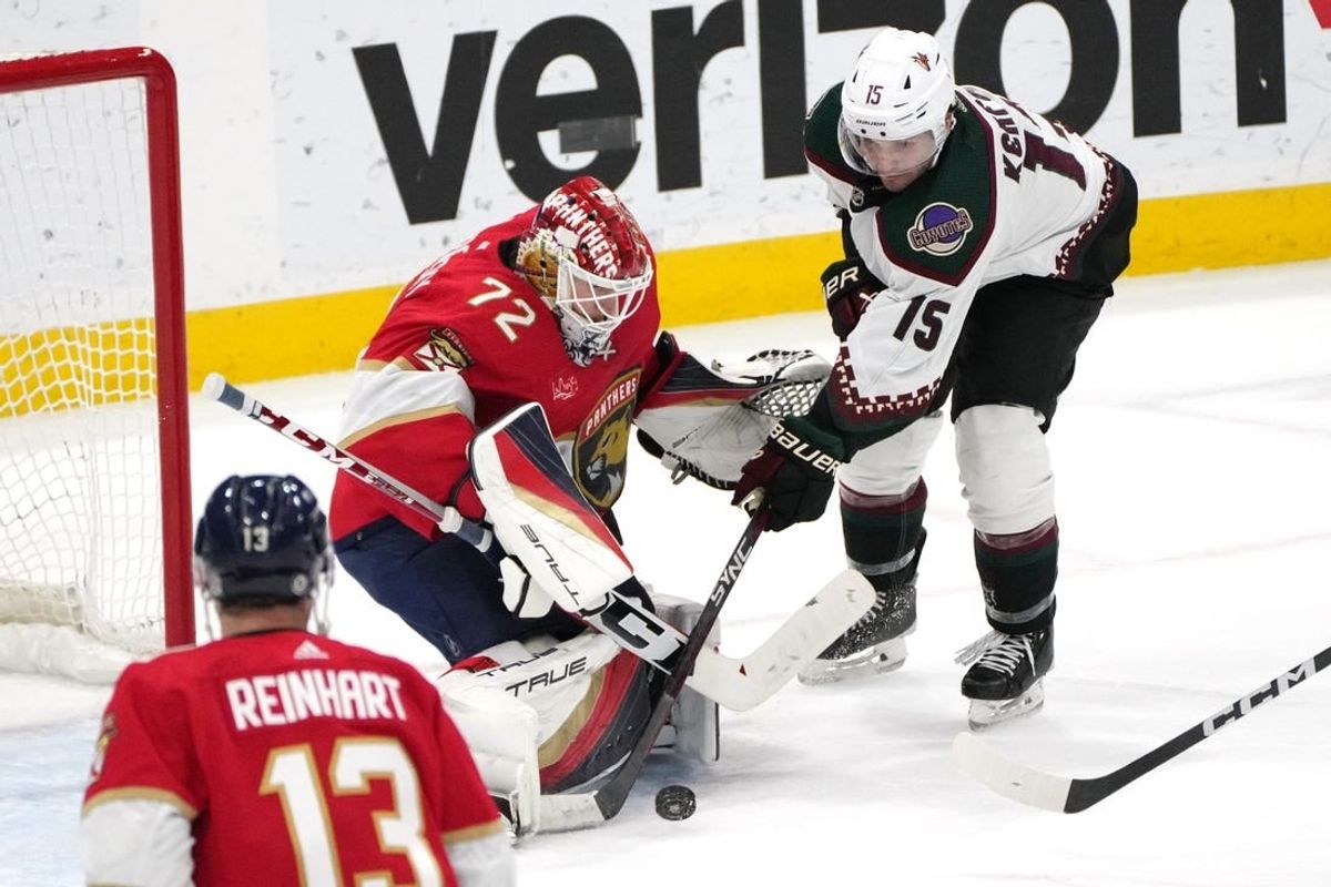 Jan 24, 2024; Sunrise, Florida, USA; Florida Panthers goaltender Sergei Bobrovsky (72) makes a save as Arizona Coyotes center Alexander Kerfoot (15) closes in during the second period at Amerant Bank Arena.