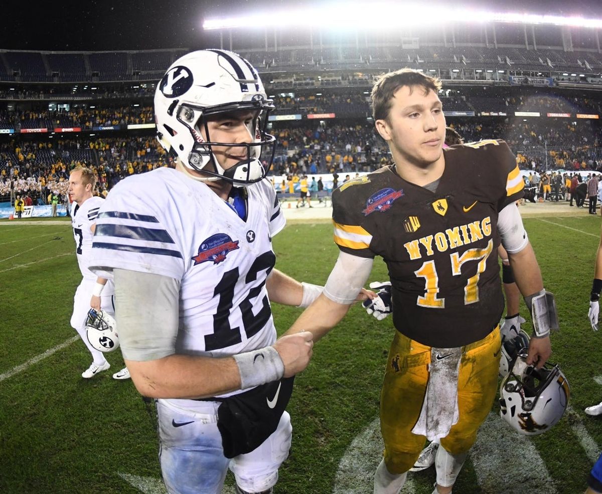 Dec 21, 2016; San Diego, CA, USA; Brigham Young Cougars quarterback Tanner Mangum (12) and Wyoming Cowboys quarterback Josh Allen (17) shake hands during the 2016 Poinsettia Bowl at Qualcomm Stadium. BYU defeated Wyoming 24-21. Mandatory Credit: Kirby Lee-Imagn Images