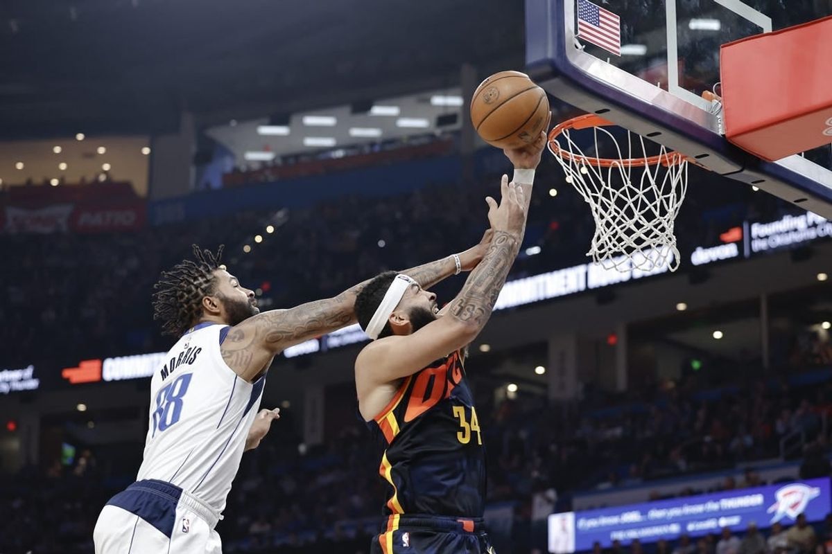 Apr 14, 2024; Oklahoma City, Oklahoma, USA; Oklahoma City Thunder forward Kenrich Williams (34) goes to the basket in front of Dallas Mavericks forward Markieff Morris (88) during the second half at Paycom Center.