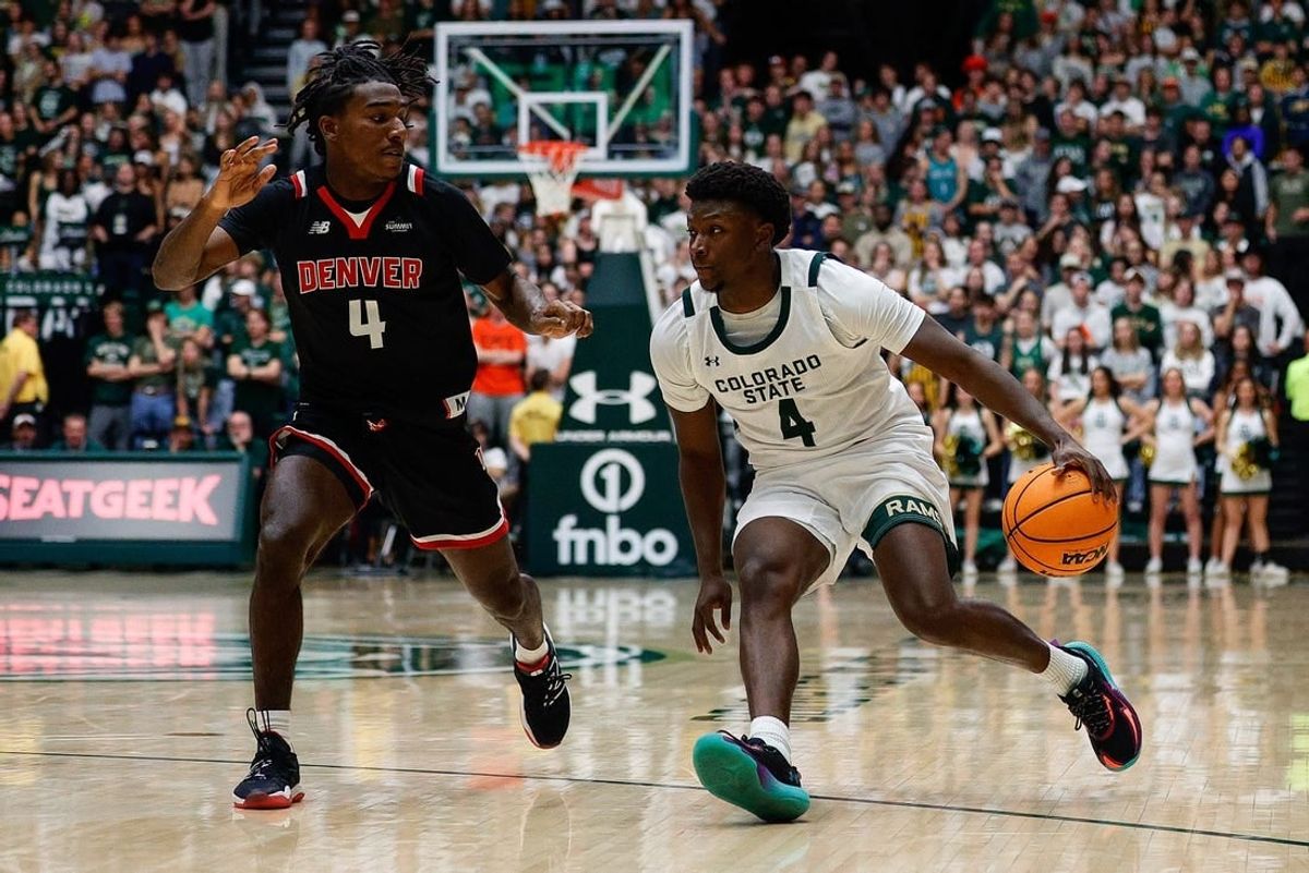 Dec 6, 2023; Fort Collins, Colorado, USA; Colorado State Rams guard Isaiah Stevens (4) controls the ball as Denver Pioneers guard DeAndre Craig (4) guards in the second half at Moby Arena.