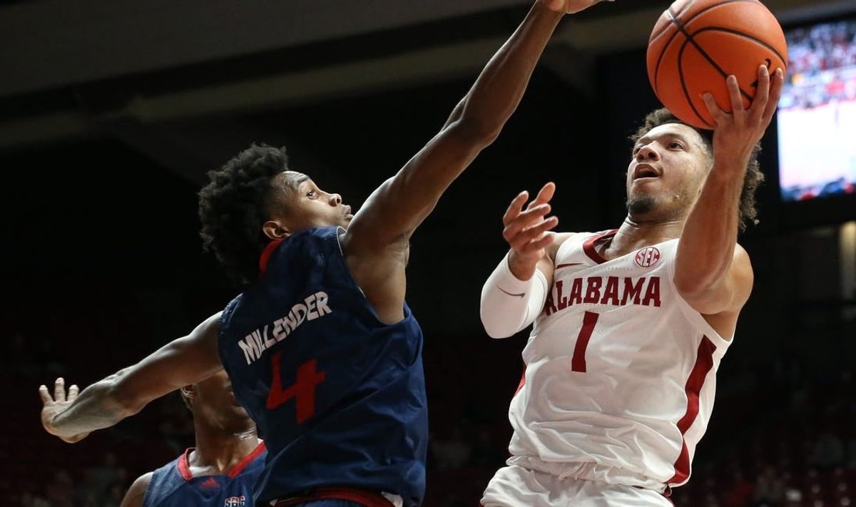 Nov 14, 2023; Tuscaloosa, Alabama, USA;  South Alabama guard Marcus Millender (4) guards a shot by Alabama guard Mark Sears (1) in the lane at Coleman Coliseum.
