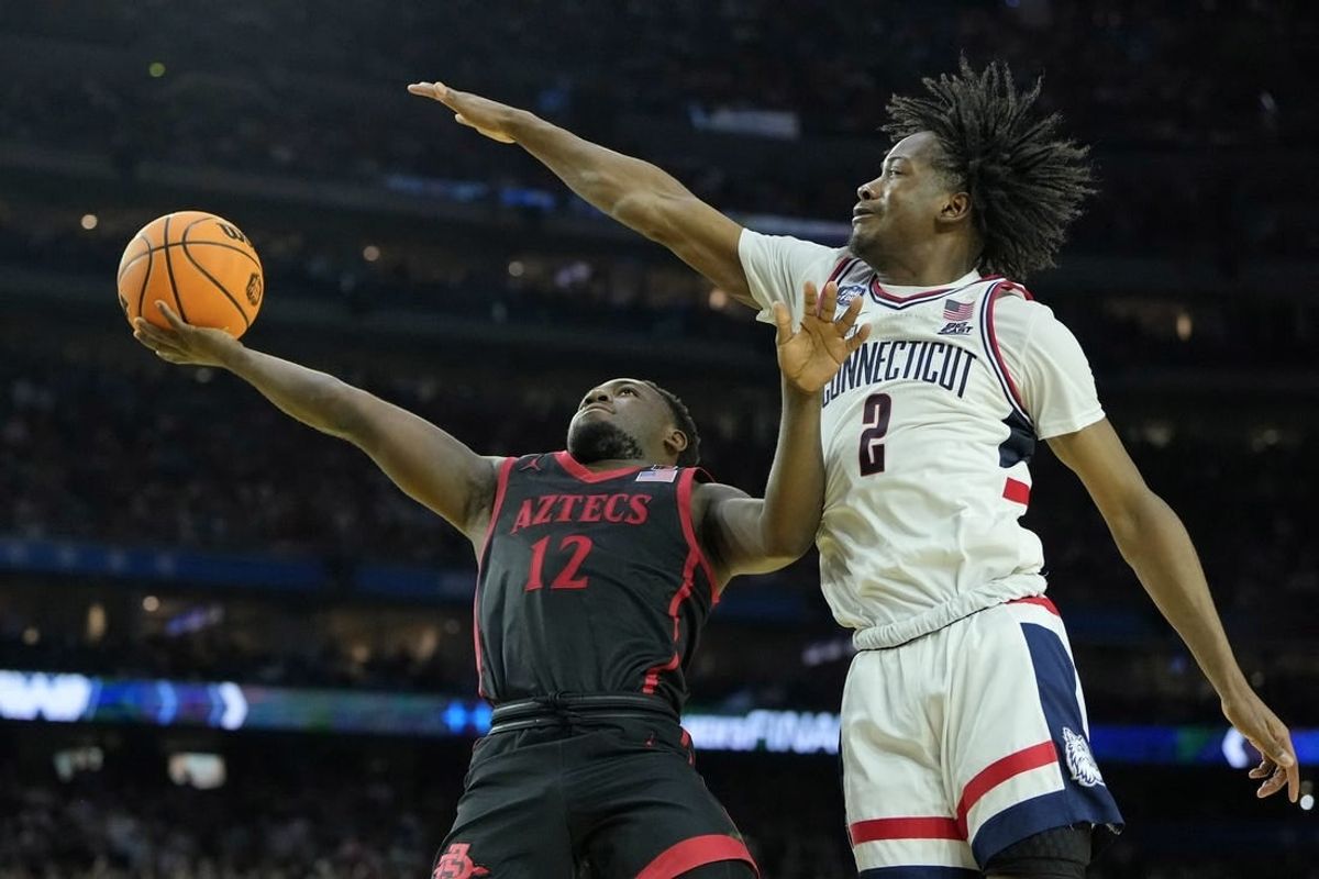 Apr 3, 2023; Houston, TX, USA; San Diego State Aztecs guard Darrion Trammell (12) shoots the ball against Connecticut Huskies guard Tristen Newton (2) during the second half in the national championship game of the 2023 NCAA Tournament at NRG Stadium.
