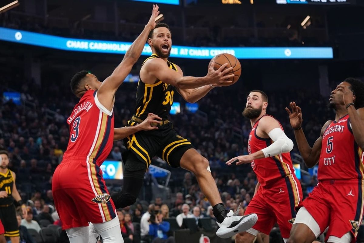 Jan 10, 2024; San Francisco, California, USA; Golden State Warriors guard Stephen Curry (30) attempts a shot next to New Orleans Pelicans guard CJ McCollum (3) in the first quarter at the Chase Center.