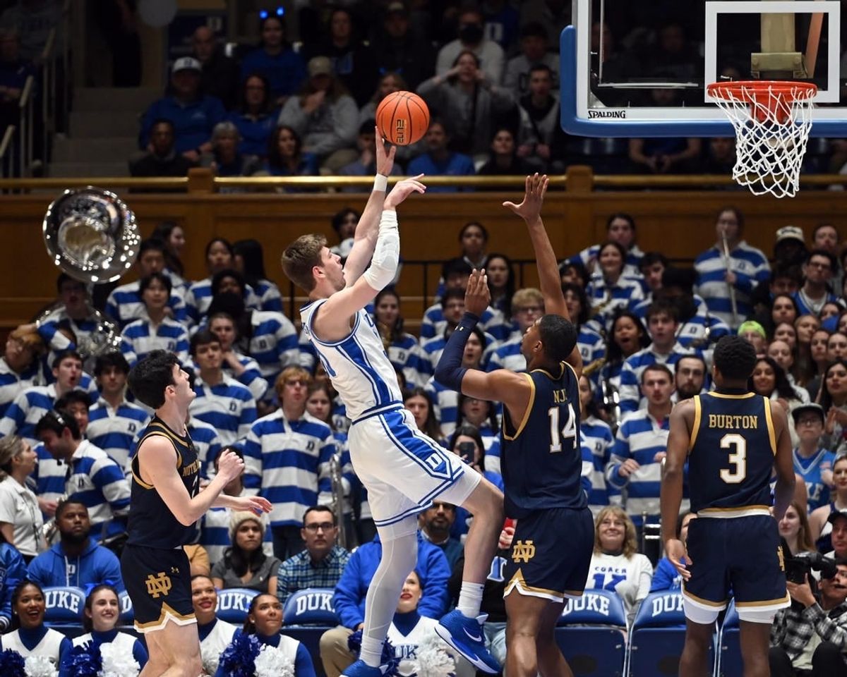 Feb 7, 2024; Durham, North Carolina, USA;  Duke Blue Devils center Kyle Filipowski (30) shoots over Notre Dame Fighting Irish forwar Kebba Nije (14) during the first half at Cameron Indoor Stadium.