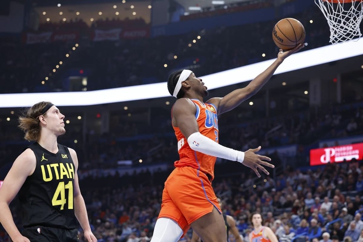 Dec 11, 2023; Oklahoma City, Oklahoma, USA; Oklahoma City Thunder guard Shai Gilgeous-Alexander (2) shoots ahead of Utah Jazz forward Kelly Olynyk (41) during the second quarter at Paycom Center.