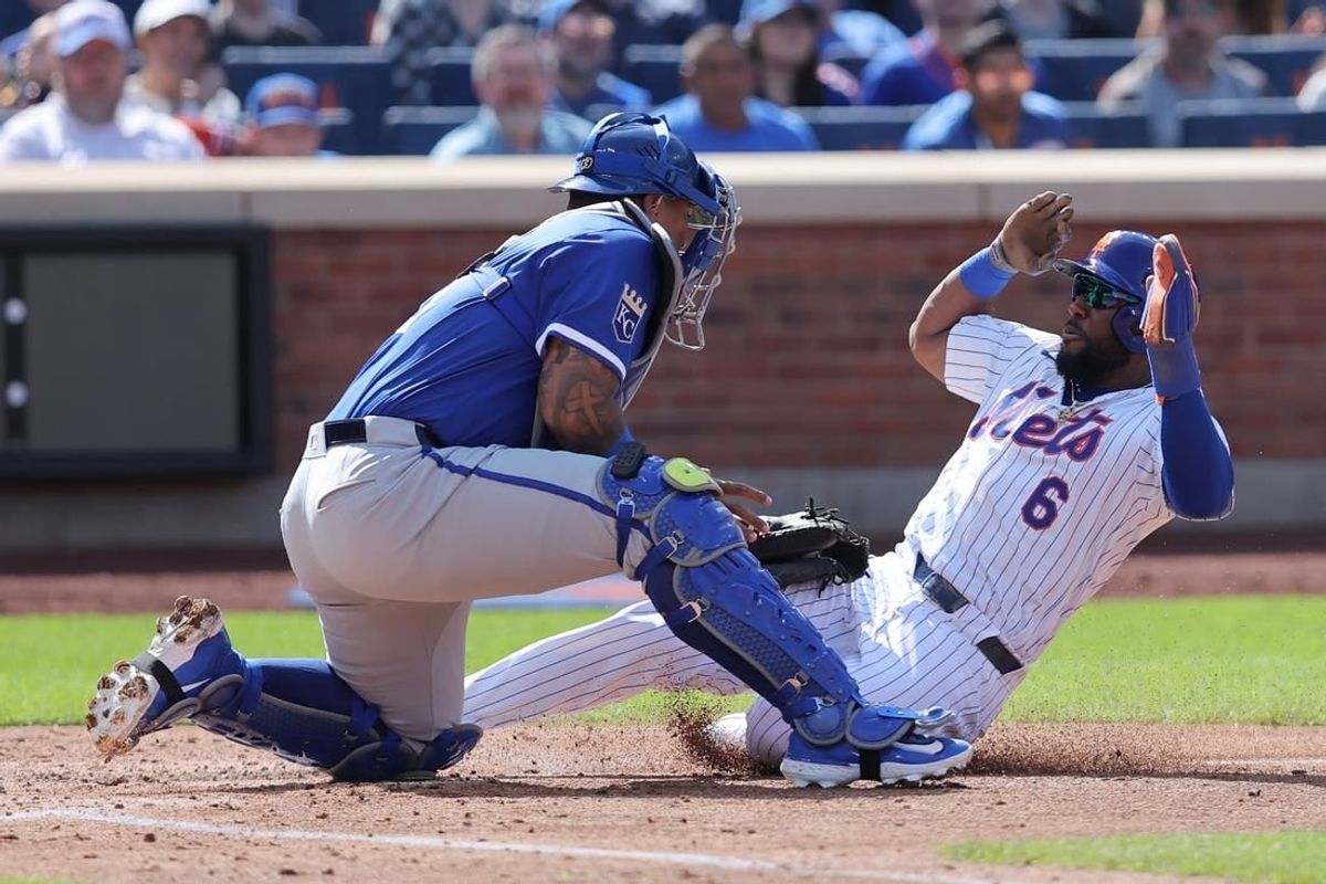 Apr 14, 2024; New York City, New York, USA; New York Mets designated hitter Starling Marte (6) is tagged out at home by Kansas City Royals catcher Salvador Perez (13) while trying to tag up on a fly ball by Mets right fielder Tyrone Taylor (not pictured) during the fourth inning at Citi Field.