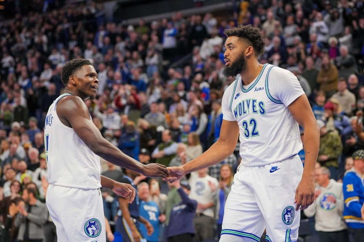 Jan 18, 2024; Minneapolis, Minnesota, USA; Minnesota Timberwolves guard Anthony Edwards (5) and center Karl-Anthony Towns (32) celebrate against the Memphis Grizzlies in the fourth quarter at Target Center.