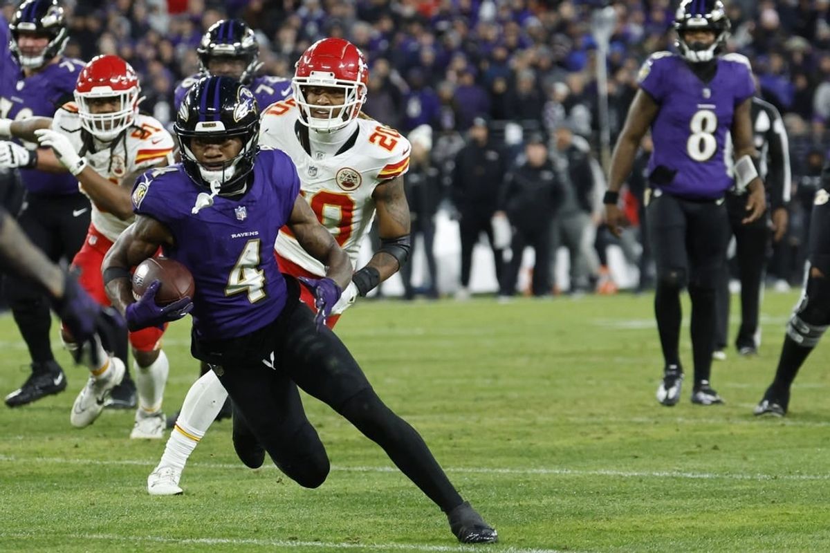 Jan 28, 2024; Baltimore, Maryland, USA; Baltimore Ravens wide receiver Zay Flowers (4) runs with the ball after making a catch prior to fumbling into the end zone as Kansas City Chiefs safety Justin Reid (20) chases in the AFC Championship football game at M&T Bank Stadium.