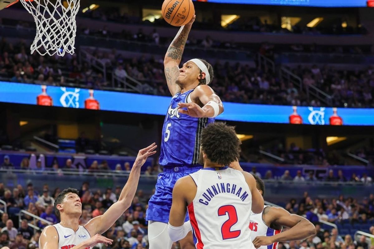 Mar 3, 2024; Orlando, Florida, USA; Orlando Magic forward Paolo Banchero (5) dunks against Detroit Pistons forward Simone Fontecchio (19) during the second quarter at KIA Center.