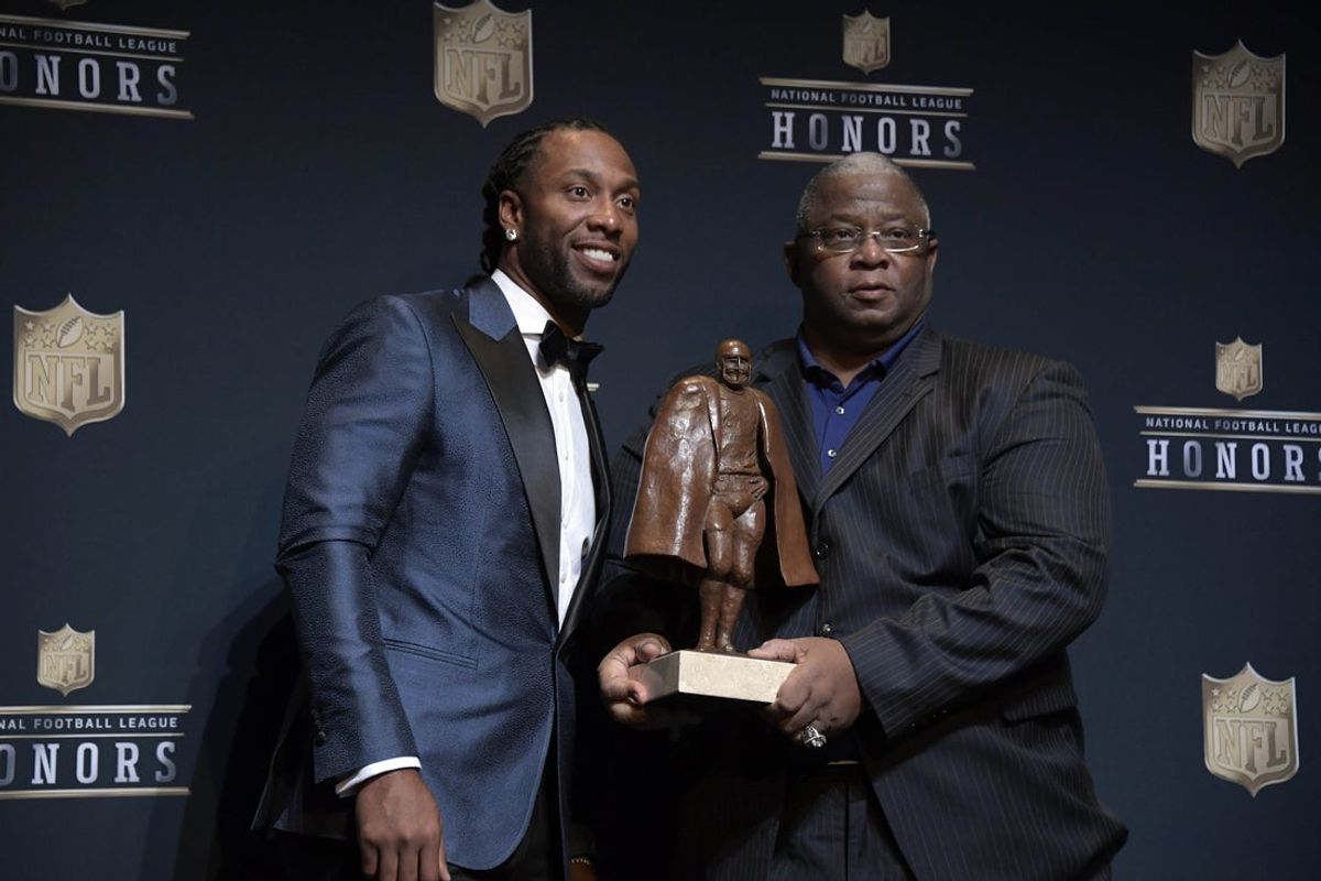 Feb 4, 2017; Houston, TX, USA; Arizona Cardinals wide receiver Larry Fitzgerald (left) poses for a photo with his father Larry Fitzgerald Sr. after being named the co-winner of the Walter Payton NFL Man of the Year during the 6th Annual NFL Honors at Wortham Theater. Mandatory Credit: Kirby Lee-Imagn Images