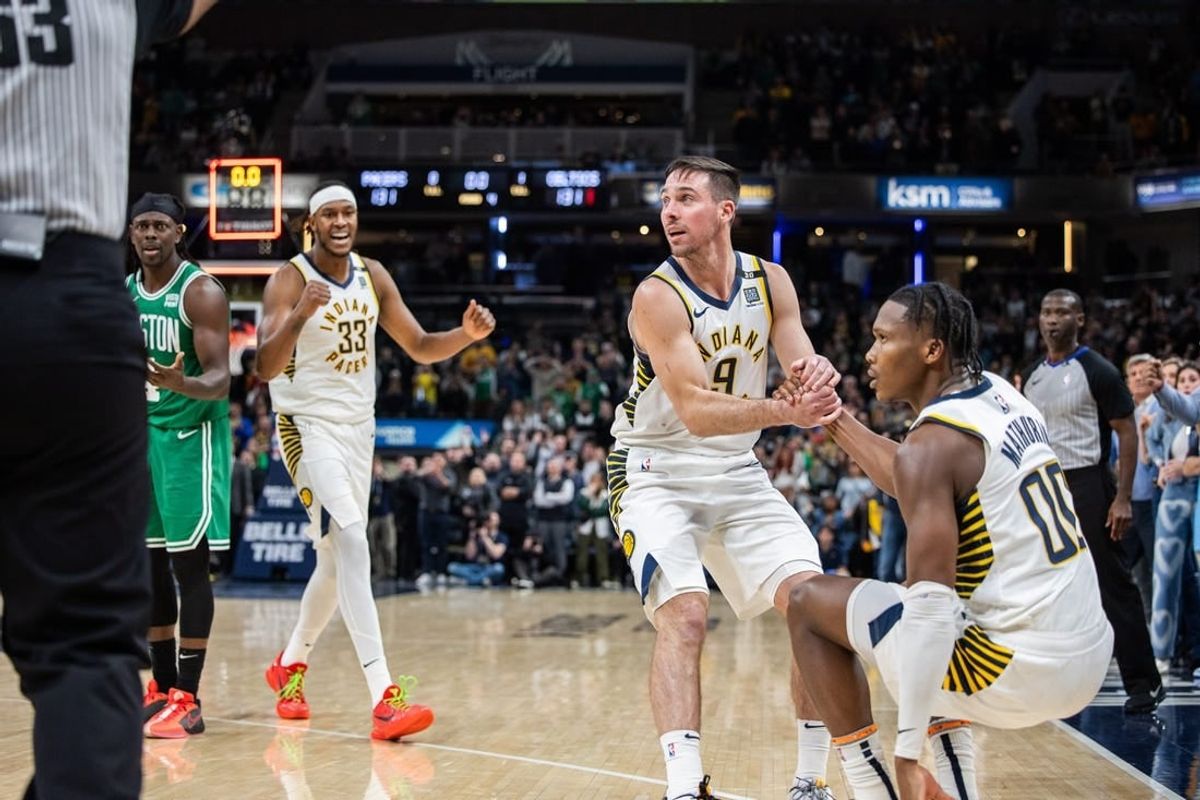 Jan 8, 2024; Indianapolis, Indiana, USA; Indiana Pacers guard T.J. McConnell (9) helps up Indiana Pacers guard Bennedict Mathurin (00) after a foul  in the second half against the Boston Celtics at Gainbridge Fieldhouse.