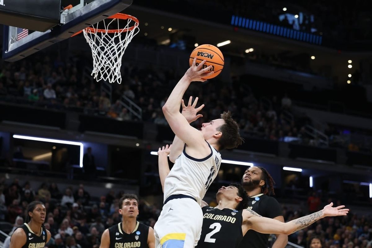 Mar 24, 2024; Indianapolis, IN, USA; Marquette Golden Eagles guard Tyler Kolek (11) shoots over Colorado Buffaloes guard KJ Simpson (2) during the first half at Gainbridge FieldHouse.