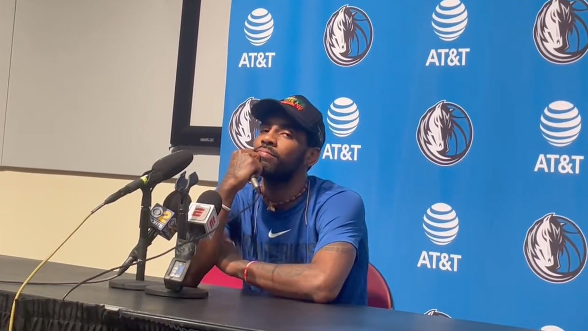 Kyrie Irving talks to the media.