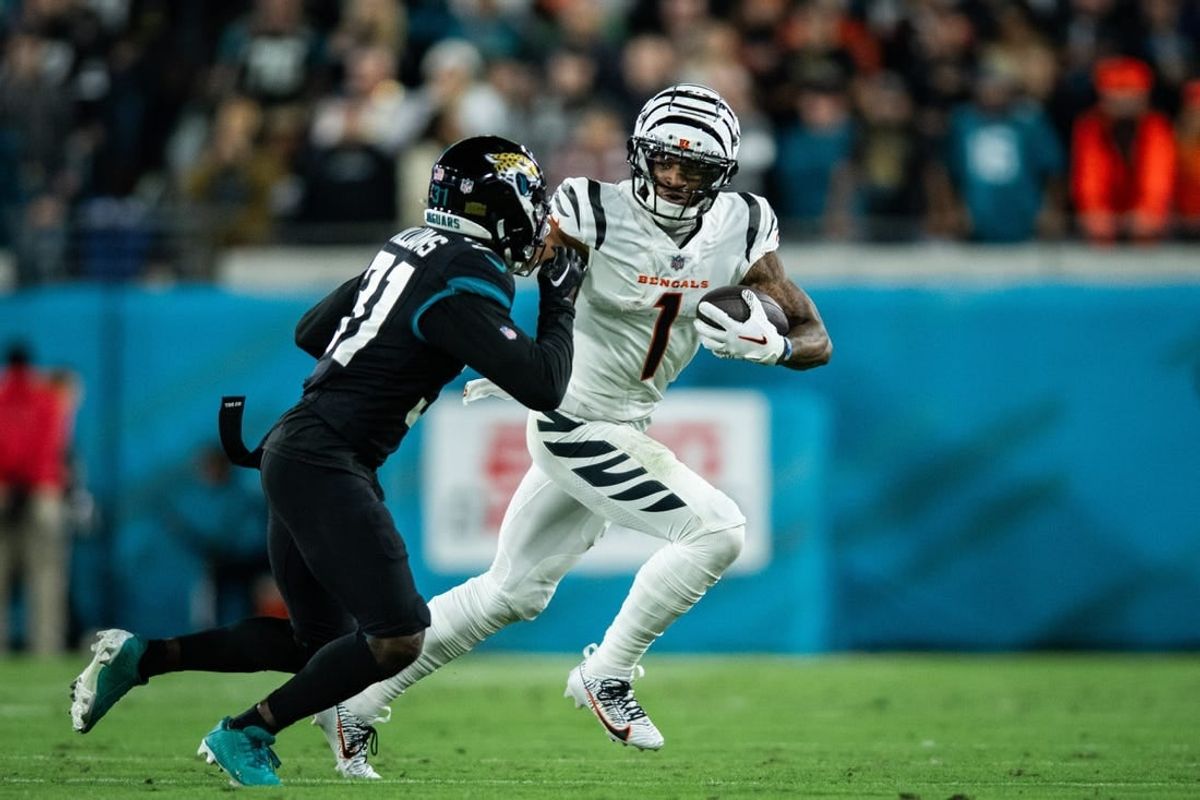 Dec 4, 2023; Jacksonville, Florida, USA; Cincinnati Bengals wide receiver Ja'Marr Chase (1) runs with the ball after the catch against Jacksonville Jaguars cornerback Darious Williams (31) in the first quarter at EverBank Stadium.
