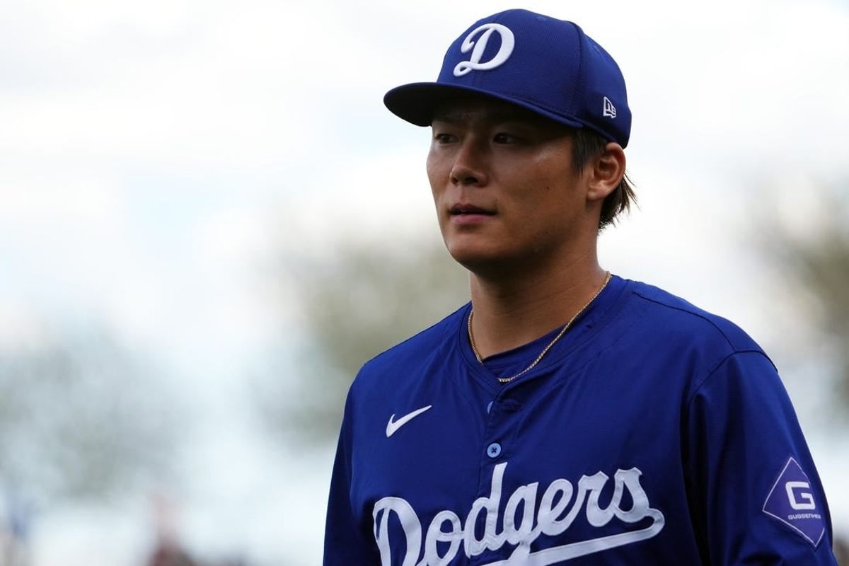 Feb 28, 2024; Surprise, Arizona, USA; Los Angeles Dodgers starting pitcher Yoshinobu Yamamoto (18) returns to the dugout during the first inning against the Texas Rangers at Surprise Stadium.