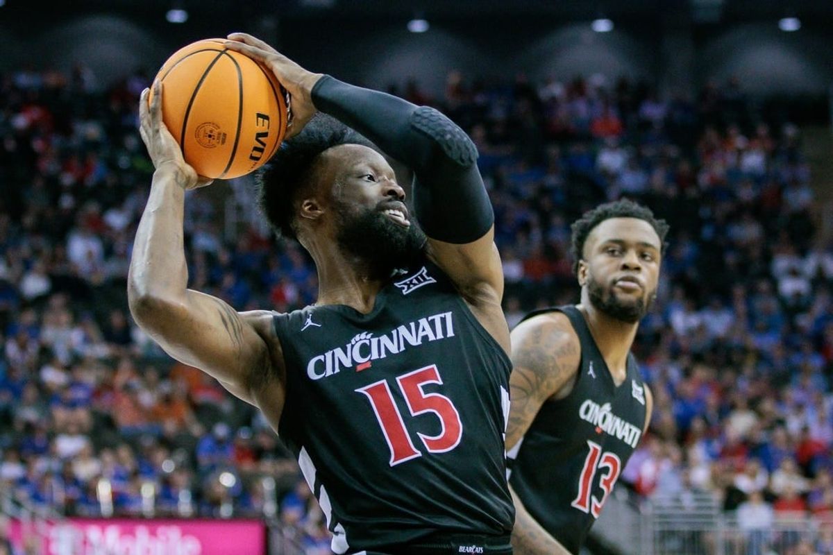 Mar 13, 2024; Kansas City, MO, USA; Cincinnati Bearcats forward John Newman III (15) grabs the rebound during the first half against the Kansas Jayhawks at T-Mobile Center.