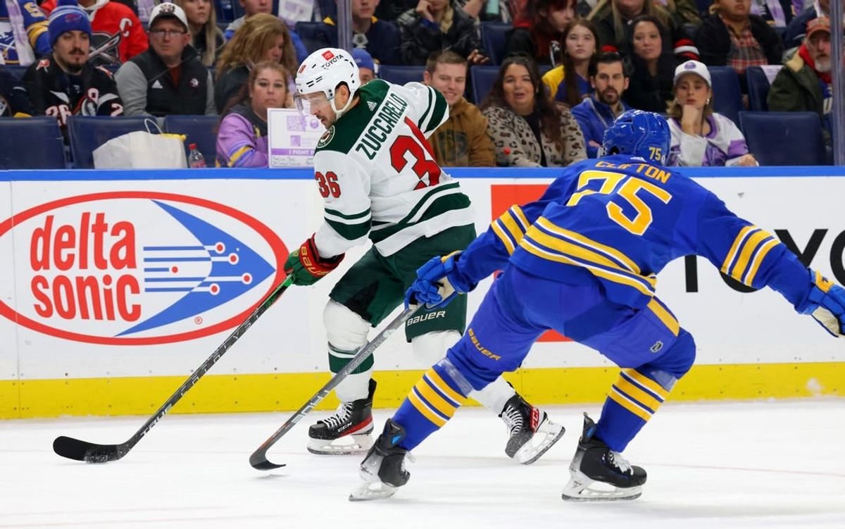Nov 10, 2023; Buffalo, New York, USA;  Minnesota Wild right wing Mats Zuccarello (36) carries the puck as Buffalo Sabres defenseman Connor Clifton (75) defends during the first period at KeyBank Center.