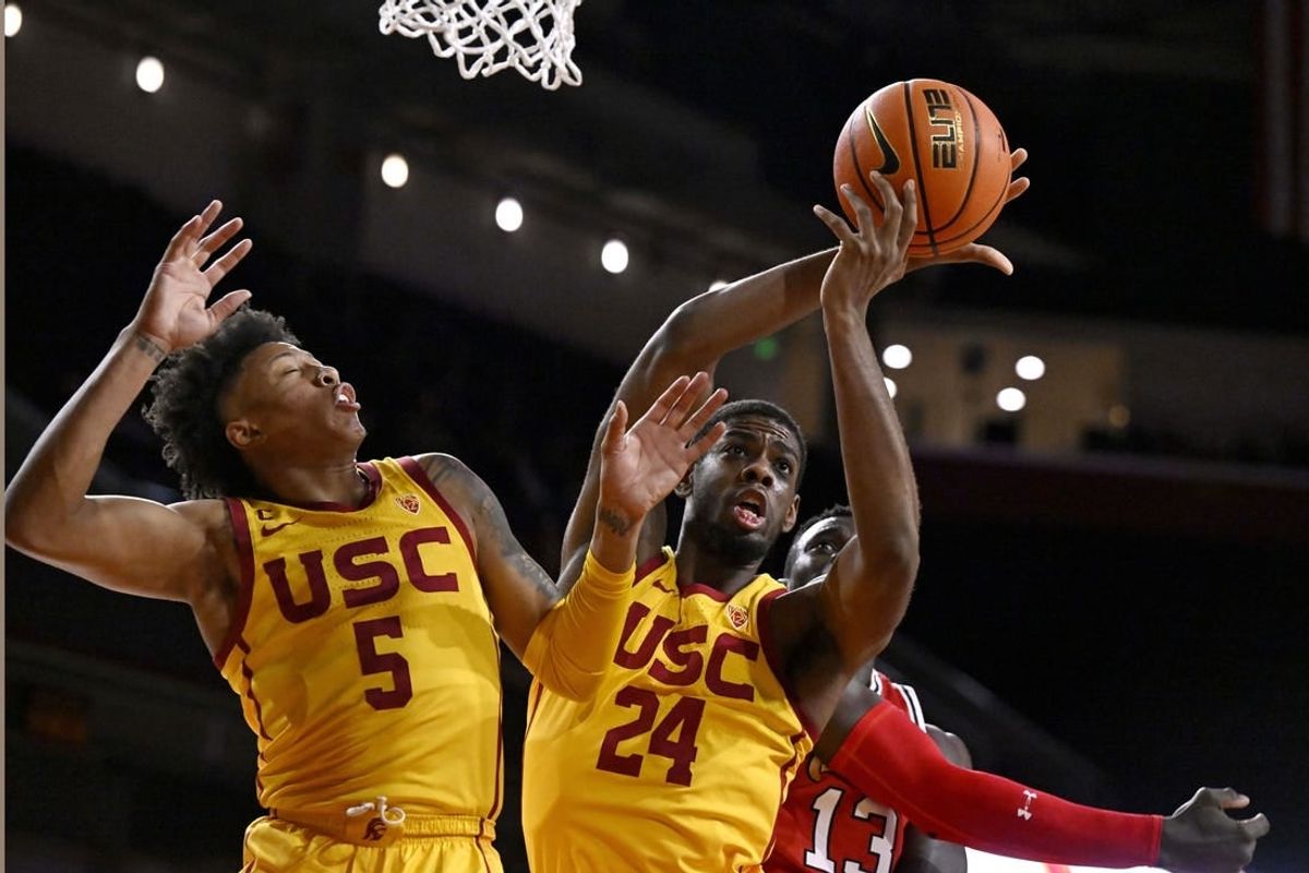 Feb 15, 2024; Los Angeles, California, USA; Southern California Trojans forward Joshua Morgan (24) gets a rebound with guard Boogie Ellis (5) against Utah Utes center Keba Keita (13) during the first half at Galen Center.
