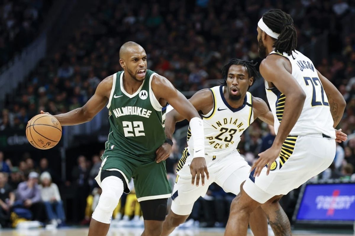 Jan 1, 2024; Milwaukee, Wisconsin, USA; Milwaukee Bucks forward Khris Middleton (22) drives to the basket against Indiana Pacers forward Isaiah Jackson (22) during the first half at Fiserv Forum.