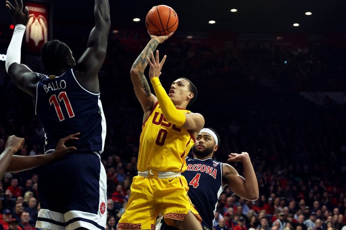 Jan 17, 2024; Tucson, Arizona, USA; USC Trojans guard Kobe Johnson (0) drives to the net against Arizona Wildcats center Oumar Ballo (11) during the first half at McKale Center.