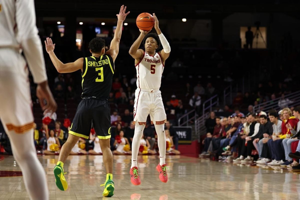 Feb 1, 2024; Los Angeles, California, USA; USC Trojans guard Boogie Ellis (5) shoots the ball over Oregon Ducks guard Jackson Shelstad (3) during the first half at Galen Center.
