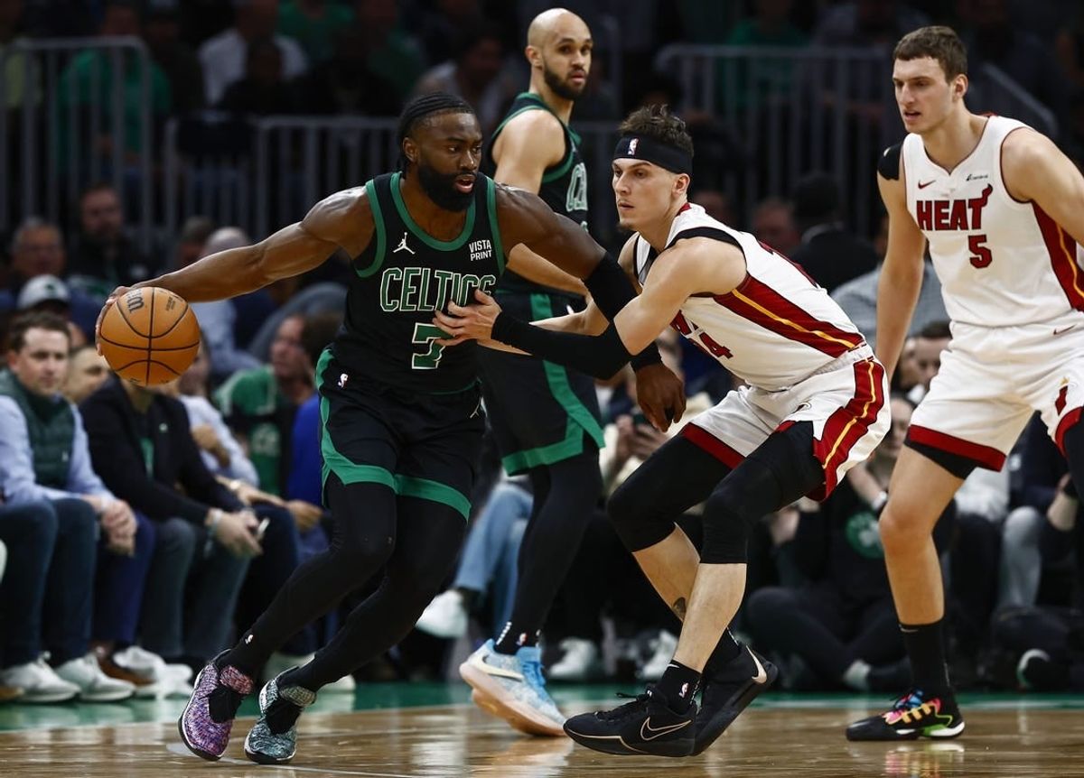 May 1, 2024; Boston, Massachusetts, USA; Boston Celtics guard Jaylen Brown (7) looks to get around Miami Heat guard Tyler Herro (14) during the first quarter of game five of the first round of the 2024 NBA playoffs at TD Garden.