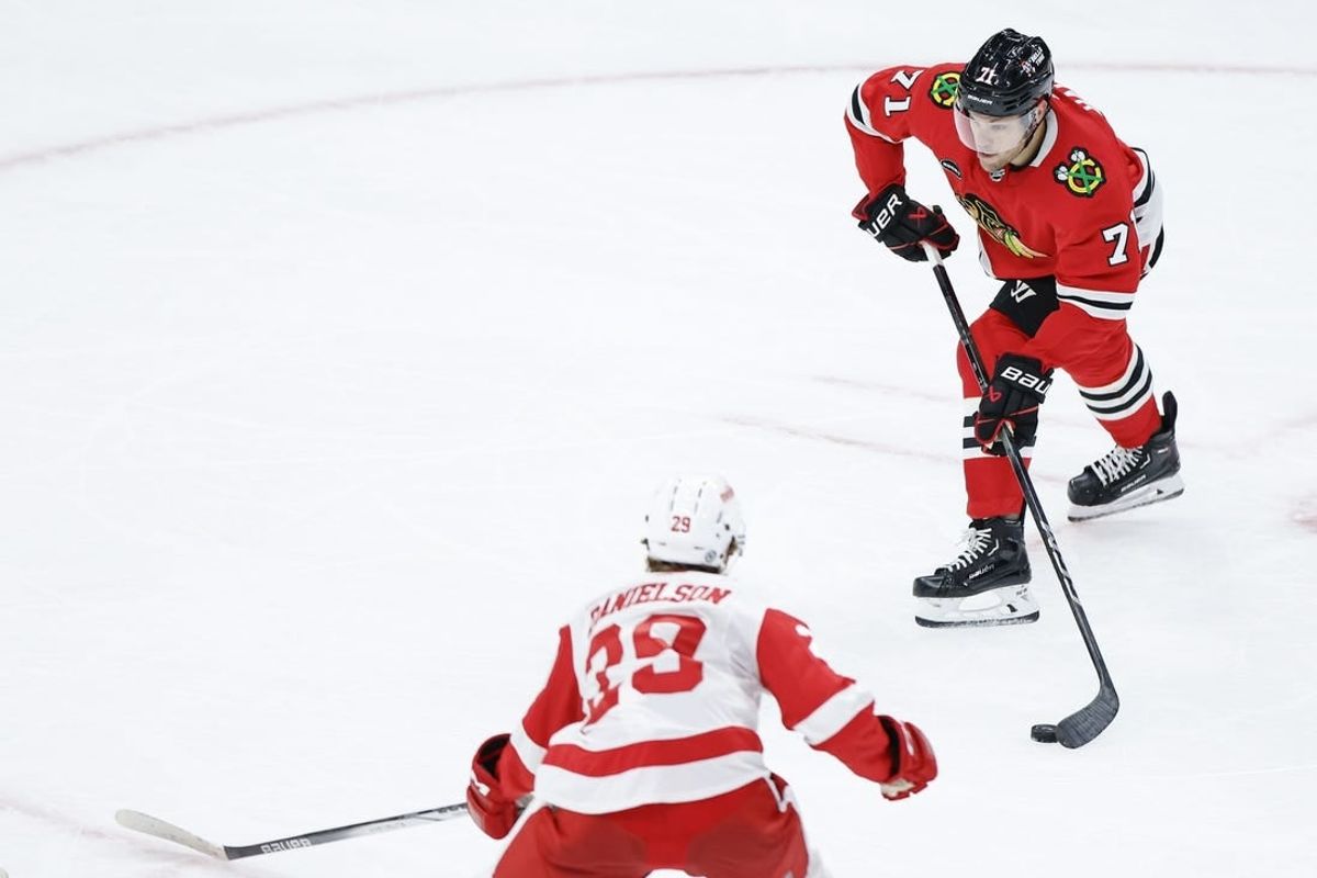 Oct 3, 2023; Chicago, Illinois, USA; Chicago Blackhawks forward Taylor Hall (71) passes the puck against Detroit Red Wings forward Nate Danielson (29) during the third period of a preseason hockey game at United Center.