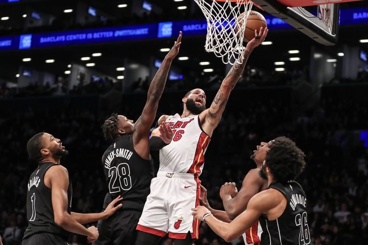 Jan 15, 2024; Brooklyn, New York, USA;  Miami Heat forward Caleb Martin (16) drives past Brooklyn Nets forward Dorian Finney-Smith (28) for a layup in the second quarter at Barclays Center.