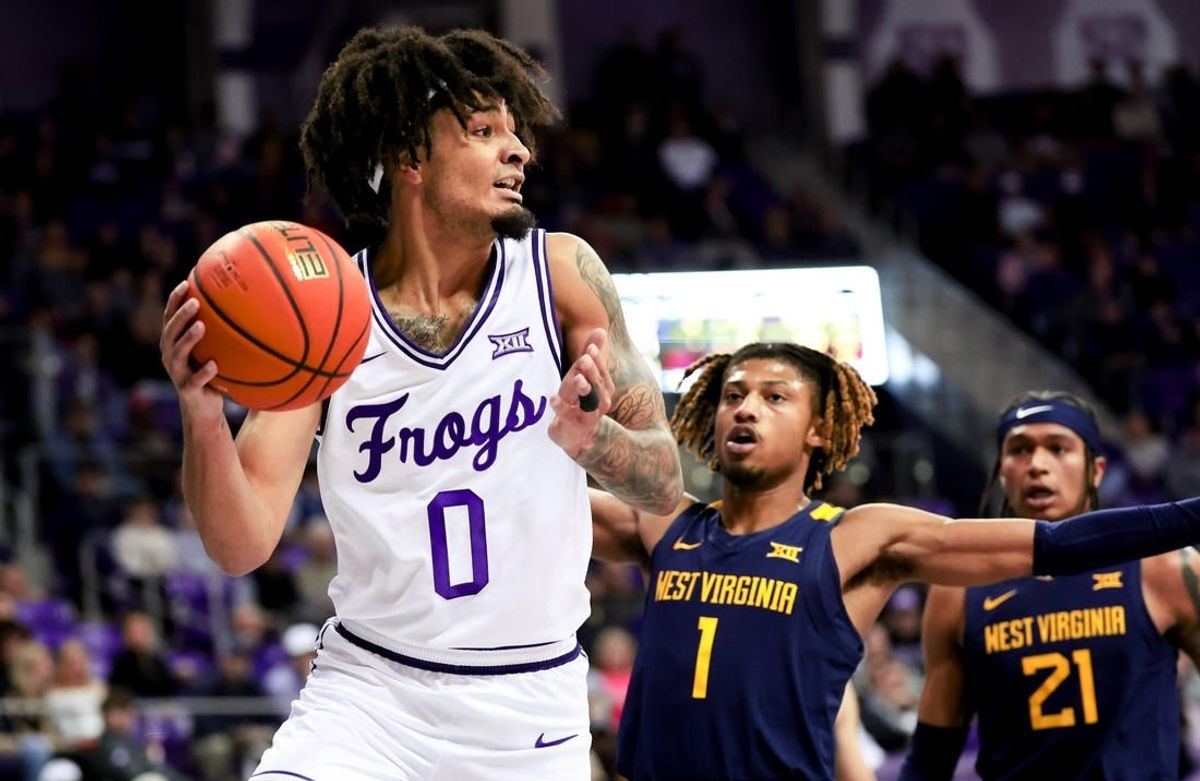 Feb 12, 2024; Fort Worth, Texas, USA;  TCU Horned Frogs guard Micah Peavy (0) looks to pass as West Virginia Mountaineers guard Noah Farrakhan (1) defends during the first half at Ed and Rae Schollmaier Arena.