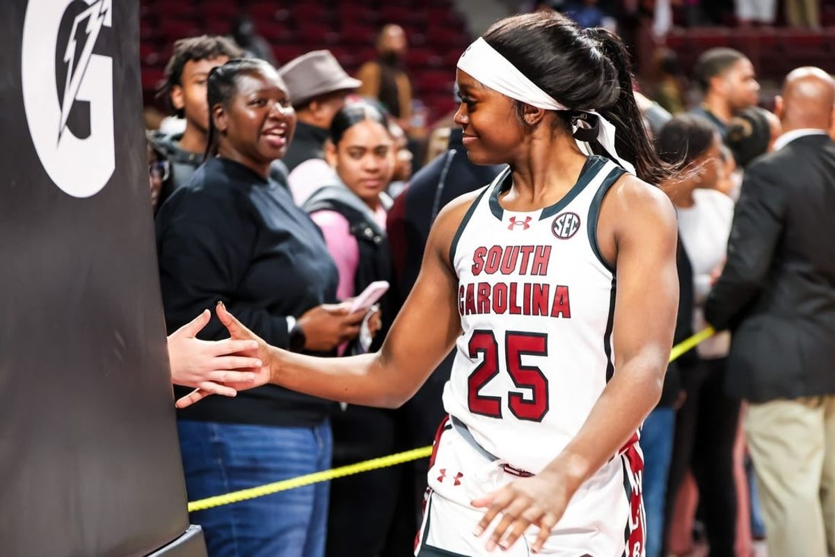 Nov 24, 2023; Columbia, South Carolina, USA; South Carolina Gamecocks guard Raven Johnson (25) high fives a fan after their win over the Mississippi Valley State Devilettes at Colonial Life Arena.