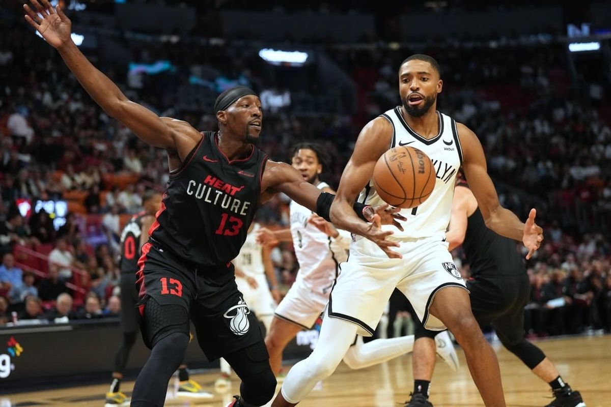 Nov 16, 2023; Miami, Florida, USA; Miami Heat center Bam Adebayo (13) tips the ball away from Brooklyn Nets forward Mikal Bridges (1) in the second half at Kaseya Center.