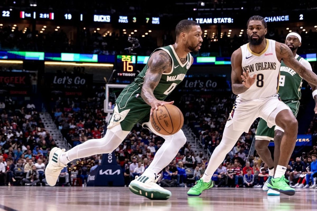 Mar 28, 2024; New Orleans, Louisiana, USA;  Milwaukee Bucks guard Damian Lillard (0) dribbles against New Orleans Pelicans forward Naji Marshall (8) during the first half at Smoothie King Center.