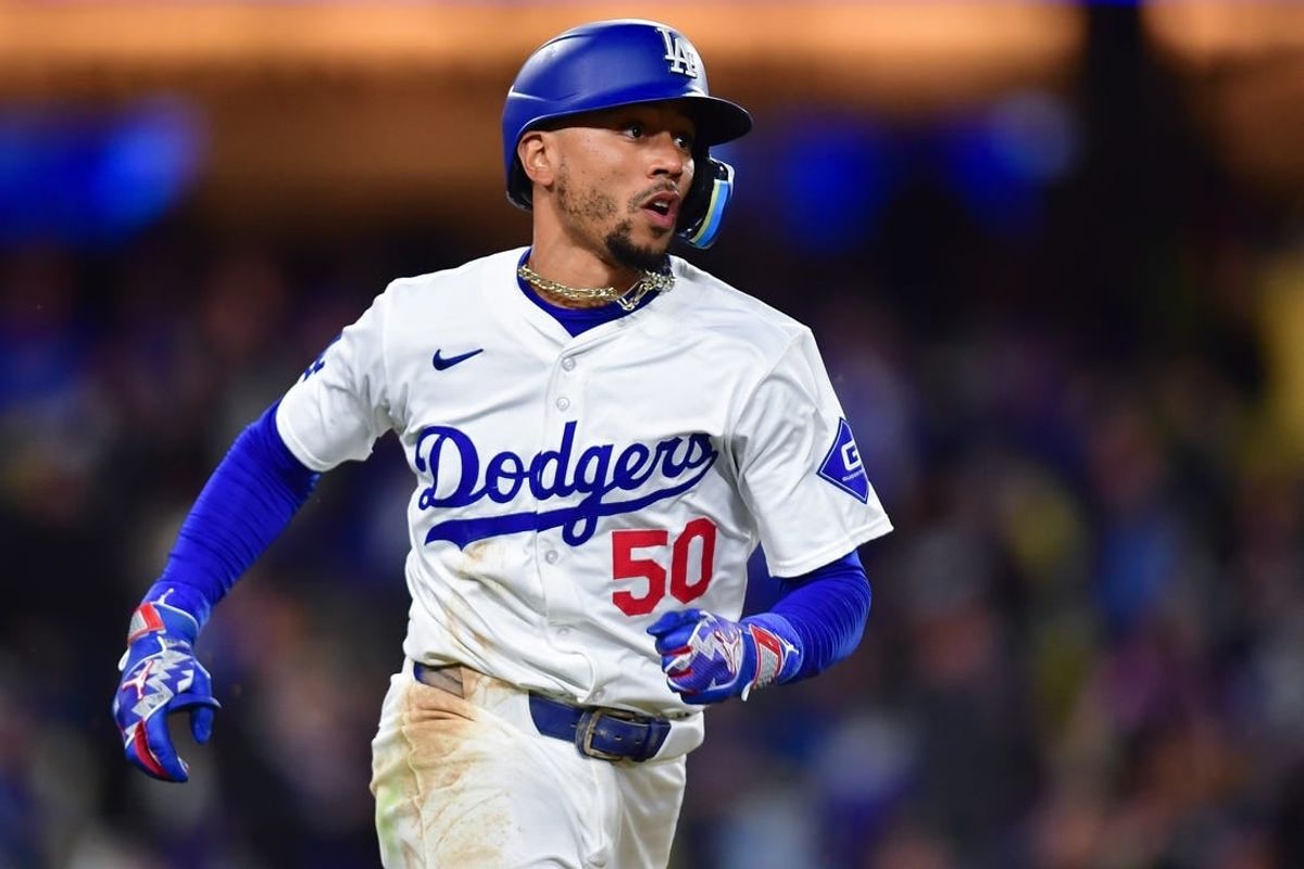 Apr 13, 2024; Los Angeles, California, USA; Los Angeles Dodgers shortstop Mookie Betts (50) runs after hitting an RBI single against the San Diego Padres during the sixth inning at Dodger Stadium.