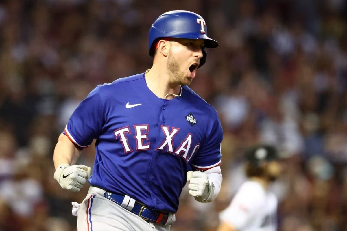 Nov 1, 2023; Phoenix, Arizona, USA; Texas Rangers catcher Mitch Garver (18) reacts after hitting a RBI single against the Arizona Diamondbacks during the sixth inning in game five of the 2023 World Series at Chase Field.