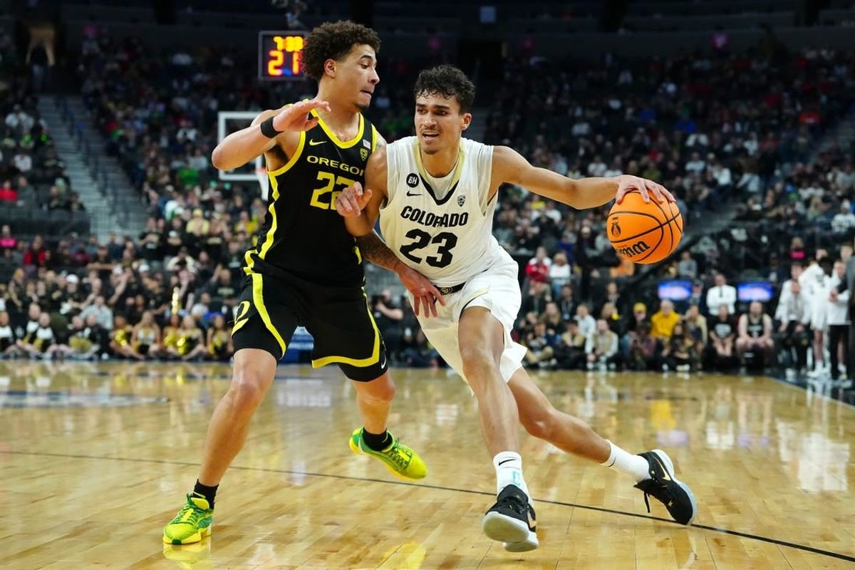 Mar 16, 2024; Las Vegas, NV, USA; Colorado Buffaloes forward Tristan da Silva (23) dribbles against Oregon Ducks guard Jadrian Tracey (22) during the first half at T-Mobile Arena.