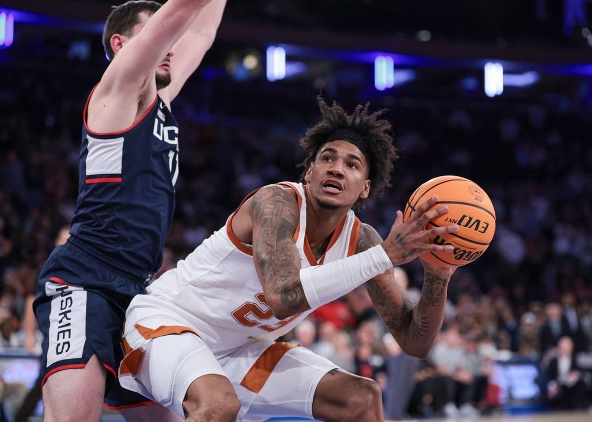 Nov 20, 2023; New York, NY, USA; Texas Longhorns forward Dillon Mitchell (23) drives to the basket against Connecticut Huskies forward Alex Karaban (11) during the second half of the Empire Classic championship game at Madison Square Garden.