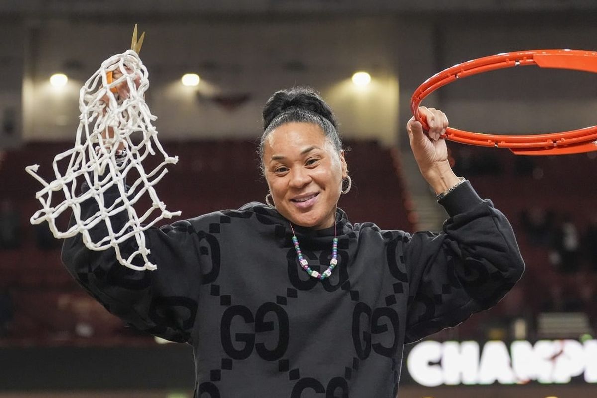 Mar 10, 2024; Greensville, SC, USA;  South Carolina Gamecocks head coach Dawn Staley cuts the net after winning the SEC championship over LSU Lady Tigers at Bon Secours Wellness Arena.