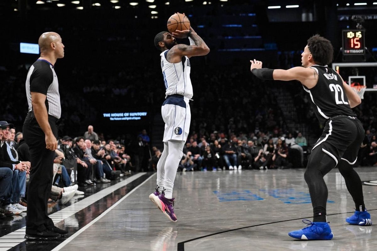 Feb 6, 2024; Brooklyn, New York, USA; Dallas Mavericks guard Kyrie Irving (11) shoots as Brooklyn Nets forward Jalen Wilson (22) defends during the second quarter at Barclays Center.