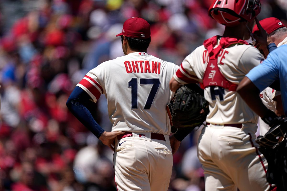 Los Angeles Angels P Shohei Ohtani walks off the field after being taken out during the second inning of a game against the Reds