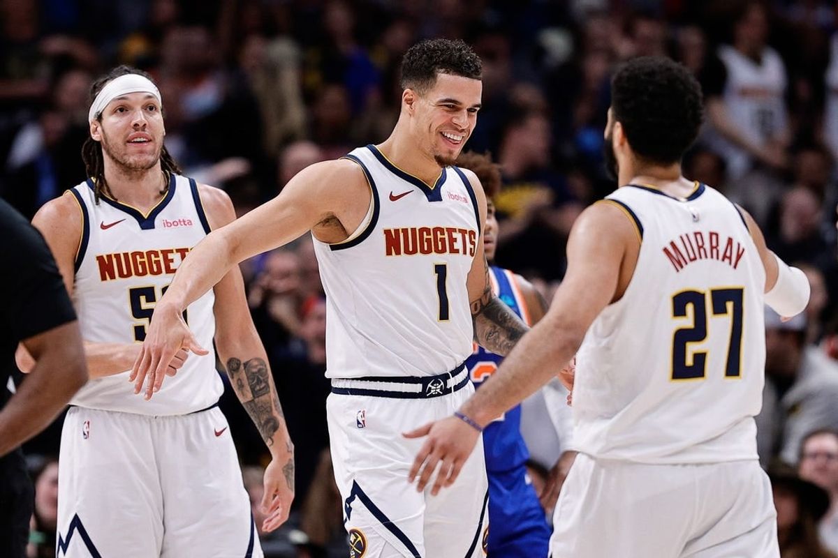 Mar 21, 2024; Denver, Colorado, USA; Denver Nuggets forward Michael Porter Jr. (1) reacts with guard Jamal Murray (27) ahead of forward Aaron Gordon (50) in the fourth quarter against the New York Knicks at Ball Arena.