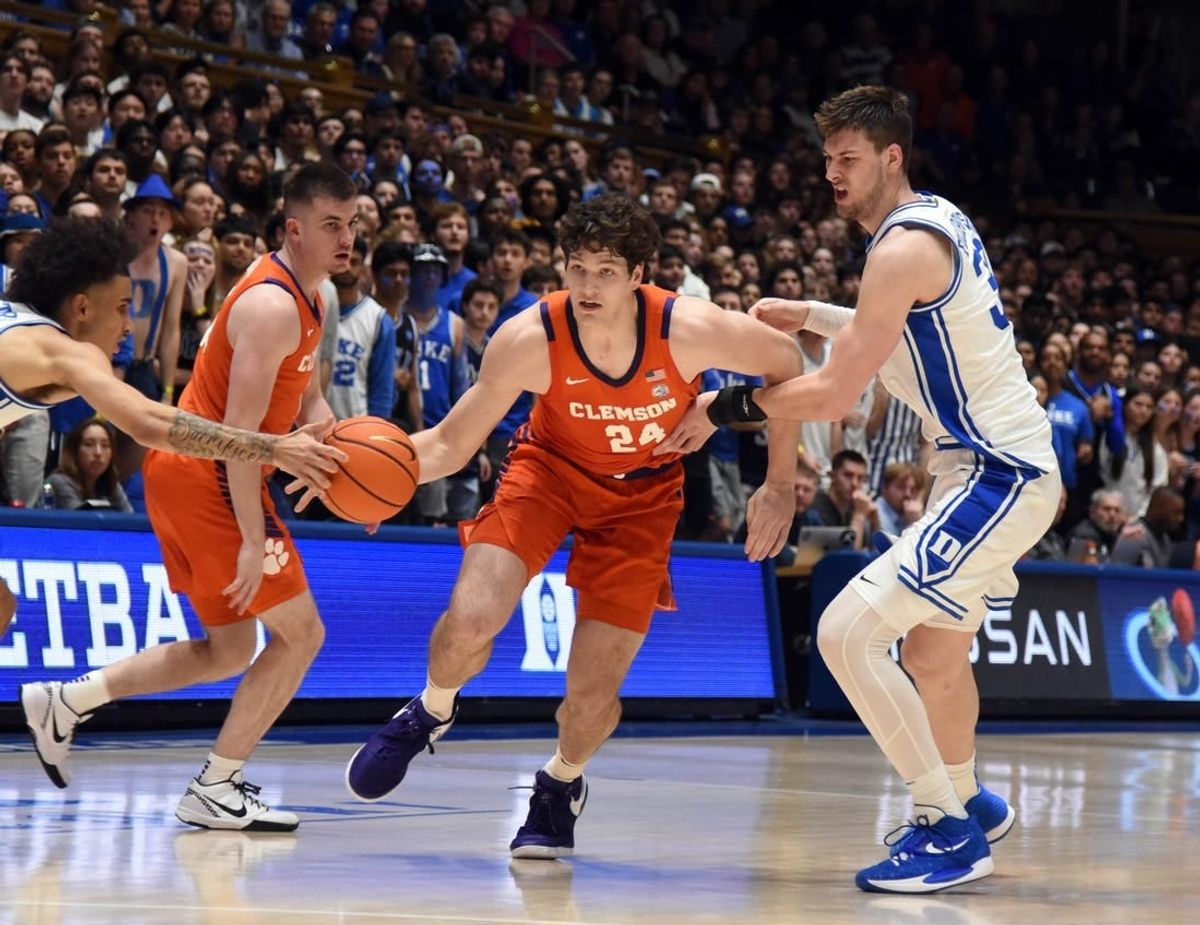Jan 27, 2024; Durham, North Carolina, USA; Clemson Tigers center PJ Hall (24) drives to the basket as Duke Blue Devils center Kyle Filipowski (30) and guard Tyrese Proctor (5) defend during the first half at Cameron Indoor Stadium.